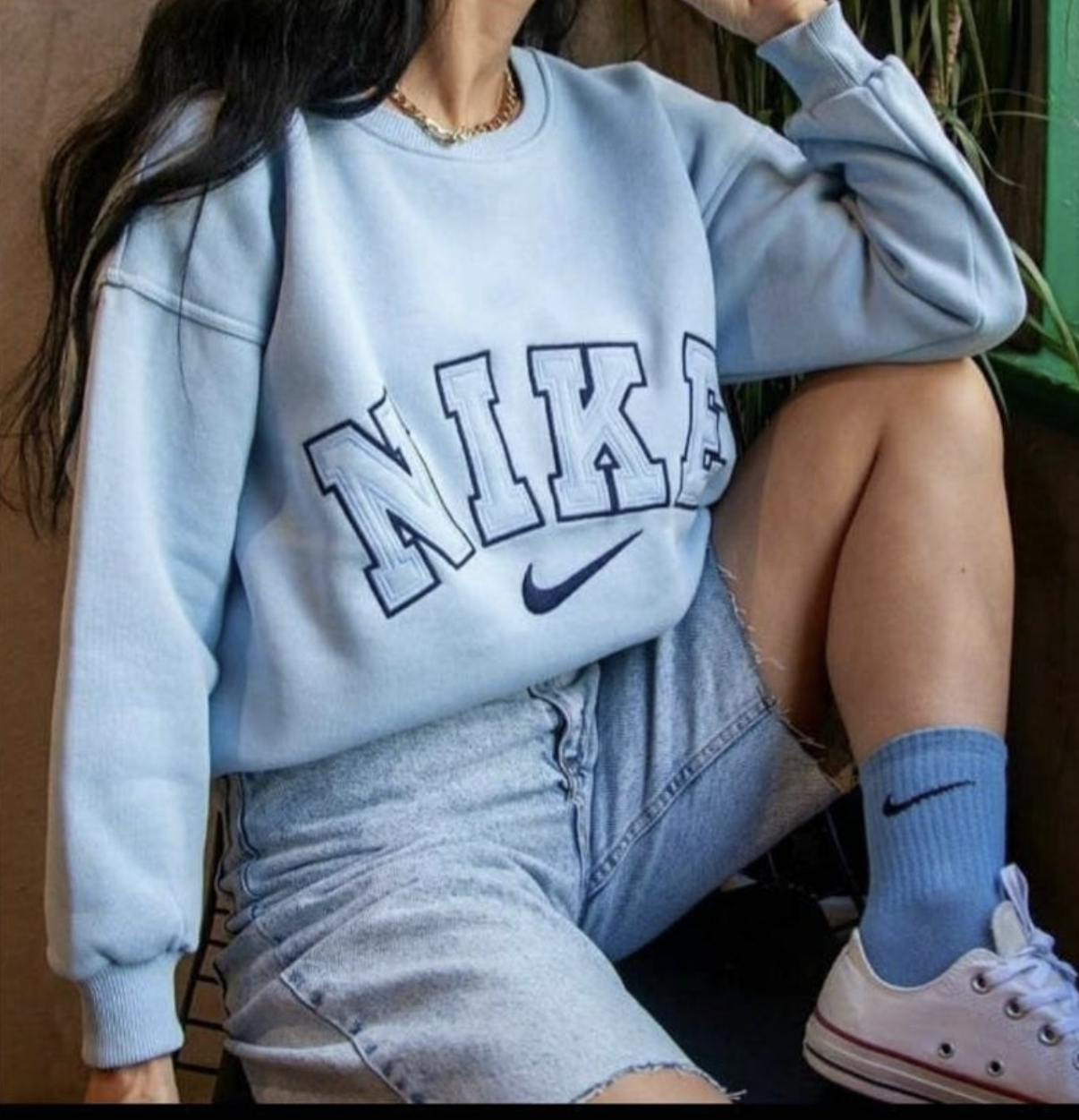 The Nike spellout embroidery crewneck in light blue.