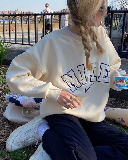 The Nike spellout embroidery crewneck in light beige.