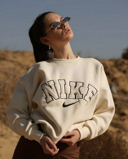 The Nike spellout embroidery crewneck in light beige.