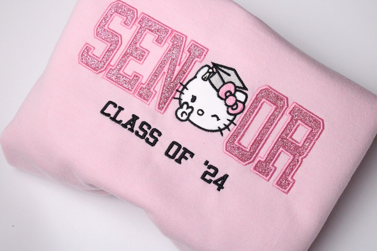 sparkle glitter hello kitty senior graduation kitty embroidered crewneck in pink