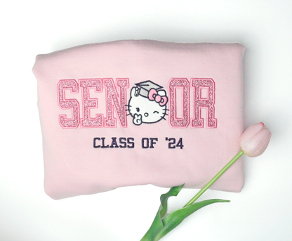 hello kitty senior graduation kitty embroidered crewneck in pink glitter