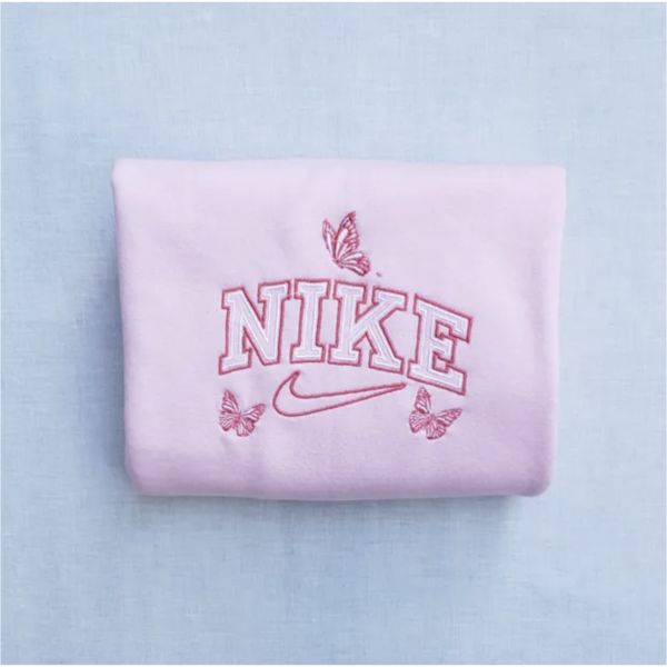 The butterfly outline nike crewneck in light pink with hot pink and white outline embroidery.