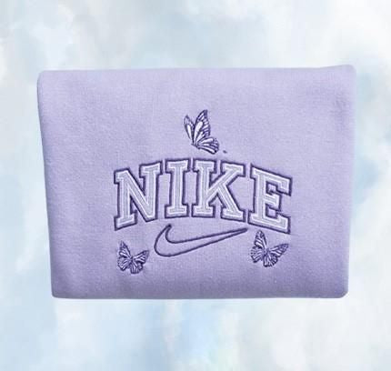 The butterfly outline nike crewneck in light purple with dark purple and white embroidery.