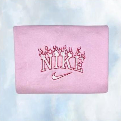 The Flames Nike embroidered crewneck in light pink with hot pink and white embroidery.