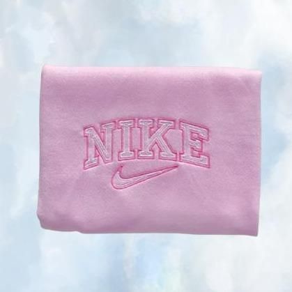 The light pink Nike swoosh embroidered crewneck with pink embroidery.