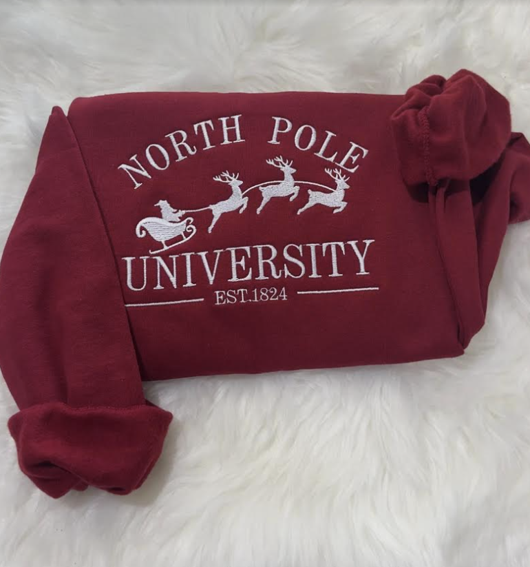 christmas theme north pole university embroidered sweatshirt in maroon