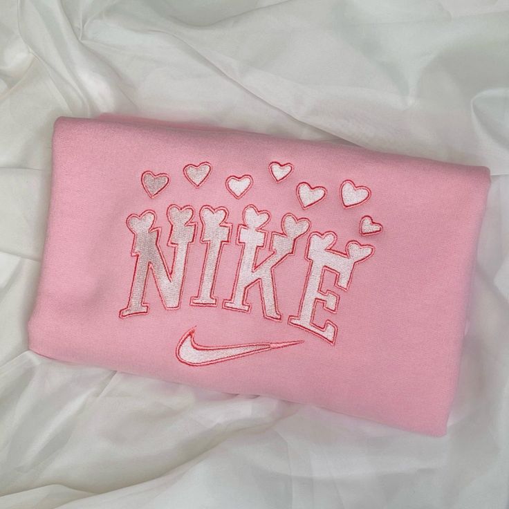 The Valentine Hearts Embroidered crewneck laid out on a white sheet.