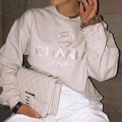 The vintage Chanel embroidered sweatshirt in light beige.
