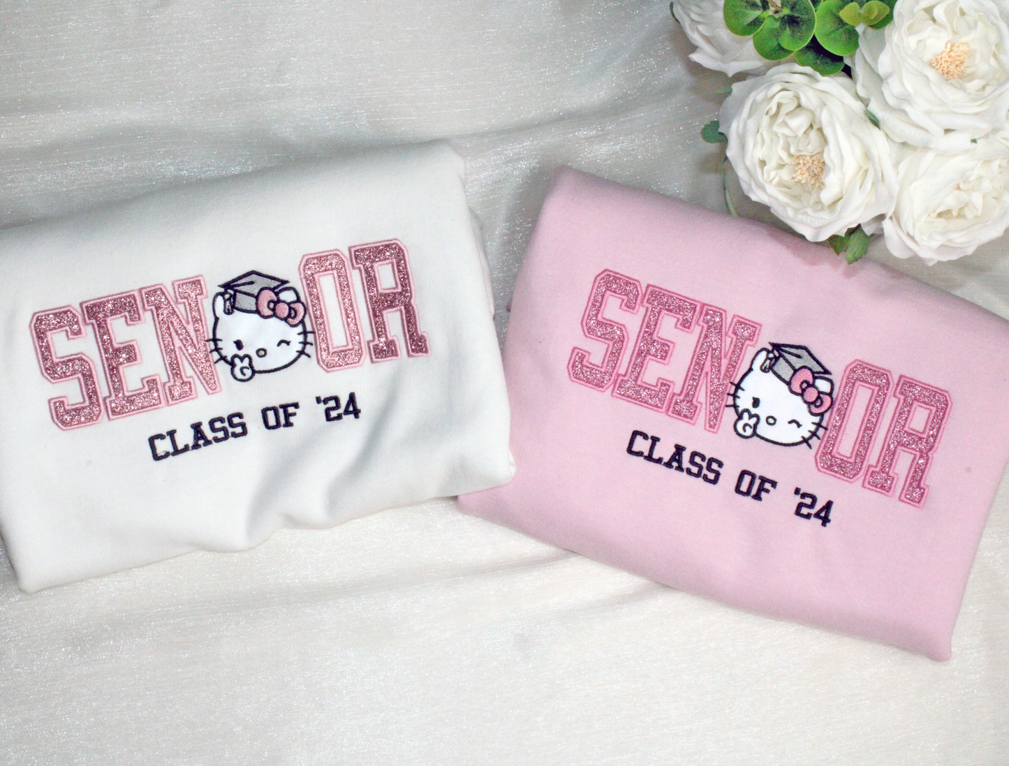 hello kitty senior graduation kitty embroidered crewneck in pink and white