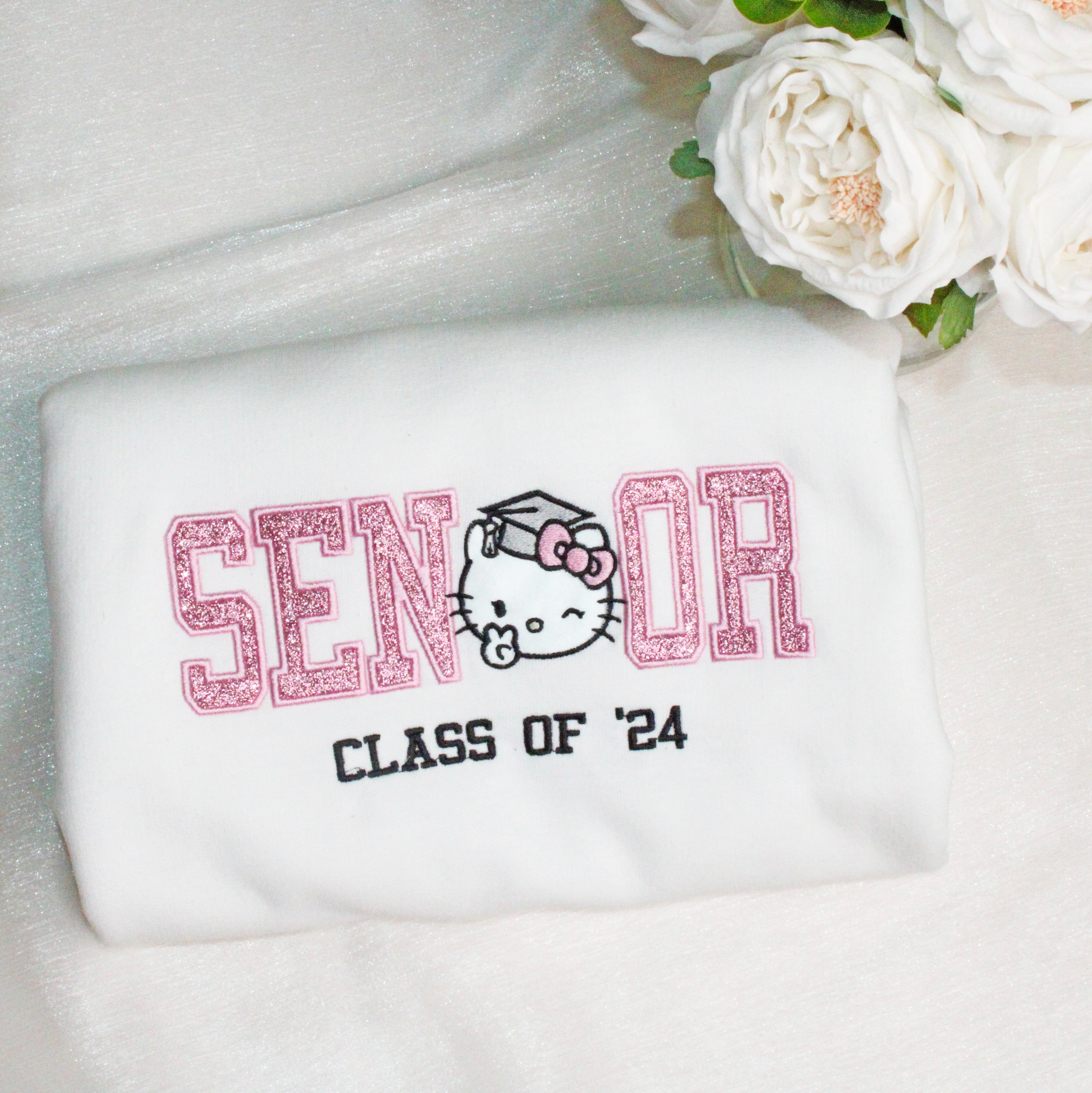 cute sparkly hello kitty senior graduation kitty embroidered crewneck in white with pink letters