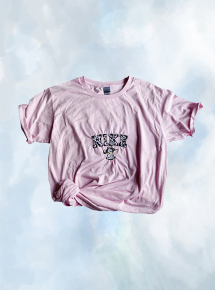 Layout of the vintage cow Nike embroidered tee in light pink.